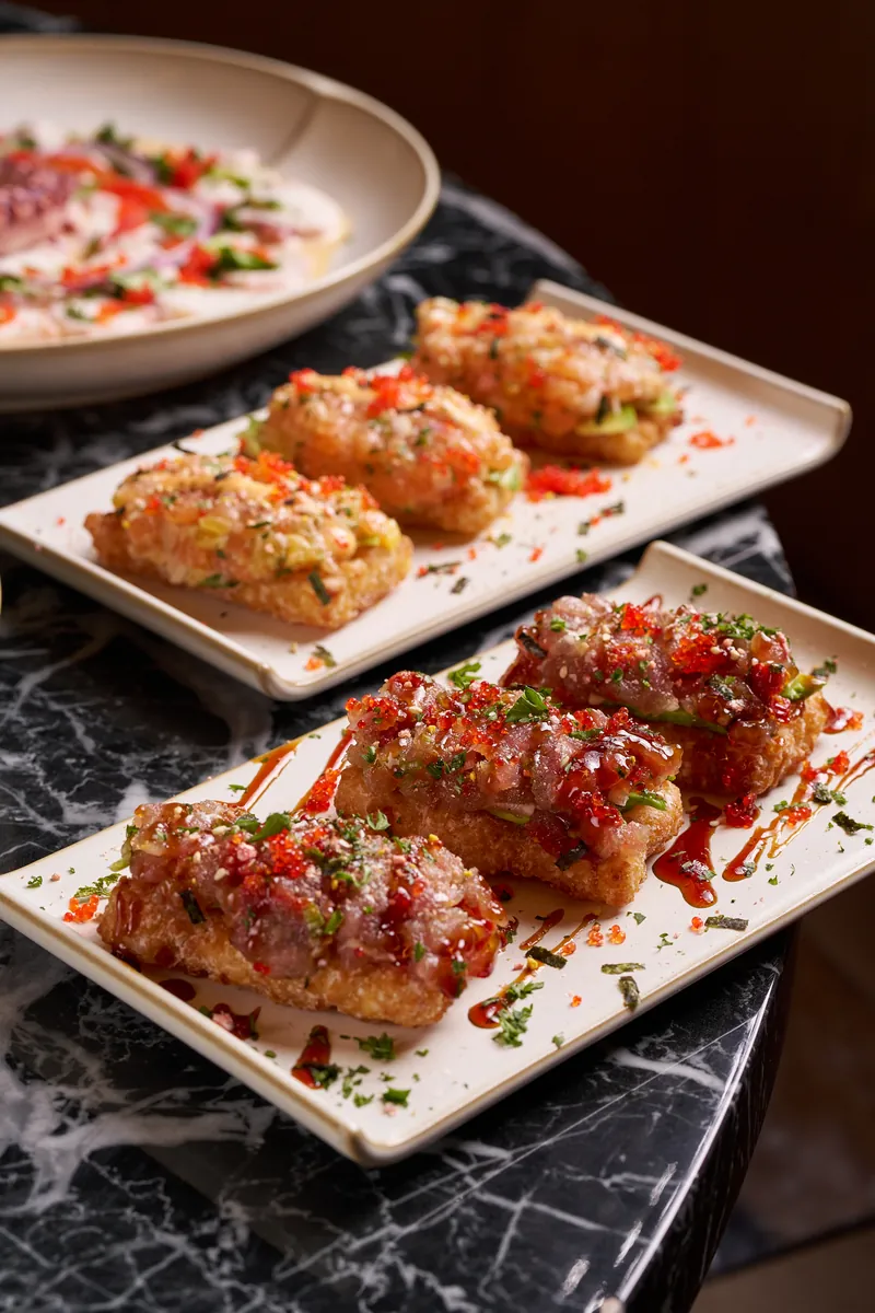 Crispy Rice topped with fresh spicy tuna tartare, avocado and jalapeño — Asian-inspired appetizer at Lo D'Alex Miami on Calle 8