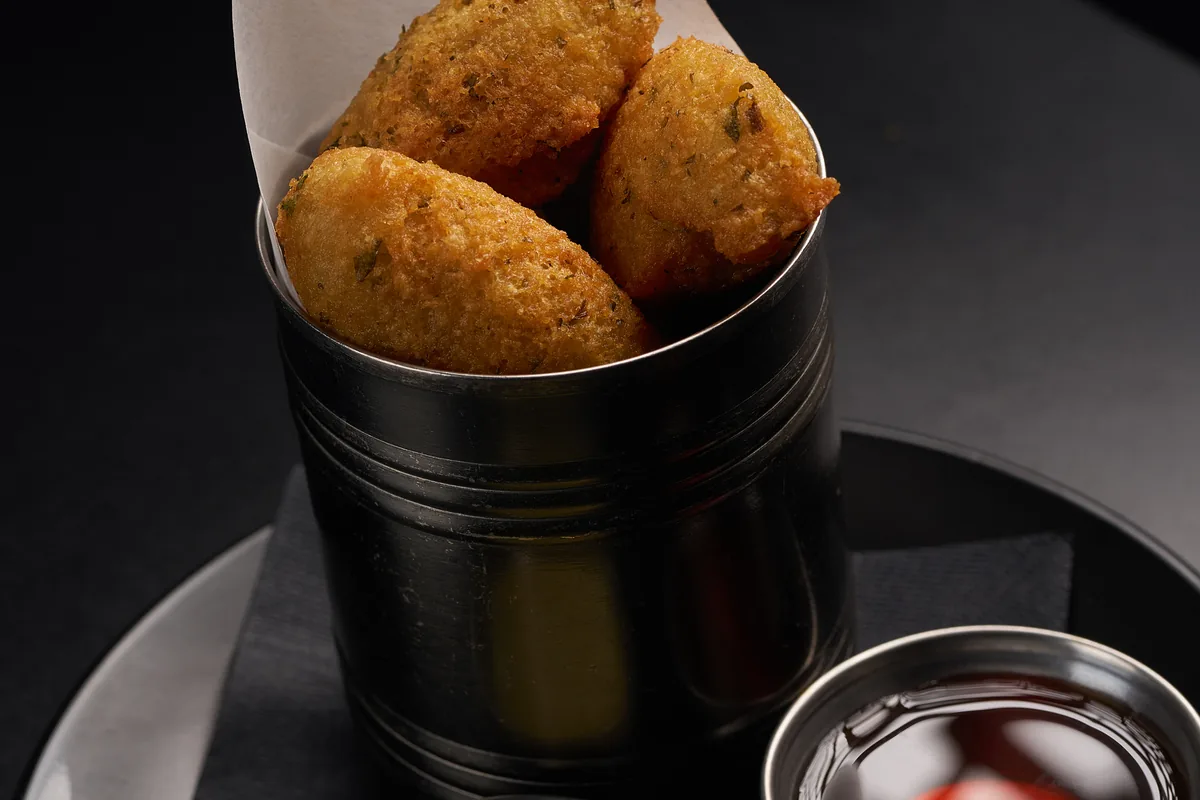 Cuban Fritura de Malanga — traditional crispy malanga root fritters served with mojo criollo at Lo D'Alex Restaurant Little Havana Miami