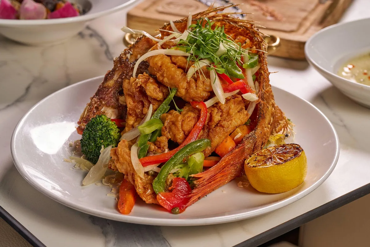 Whole fried fish with vegetables at Lo D'Alex Miami