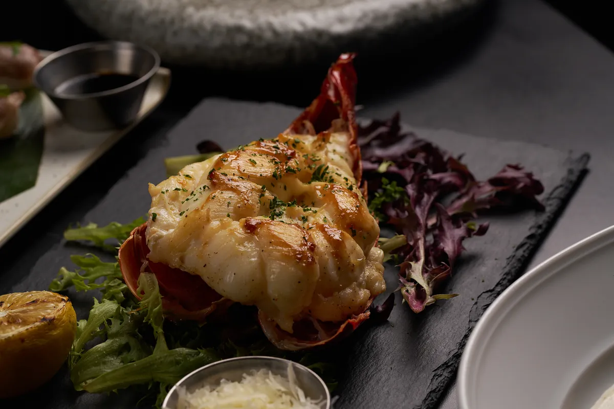 Whole grilled Maine lobster with garlic butter — seafood specialty at Lo D'Alex Restaurant Miami